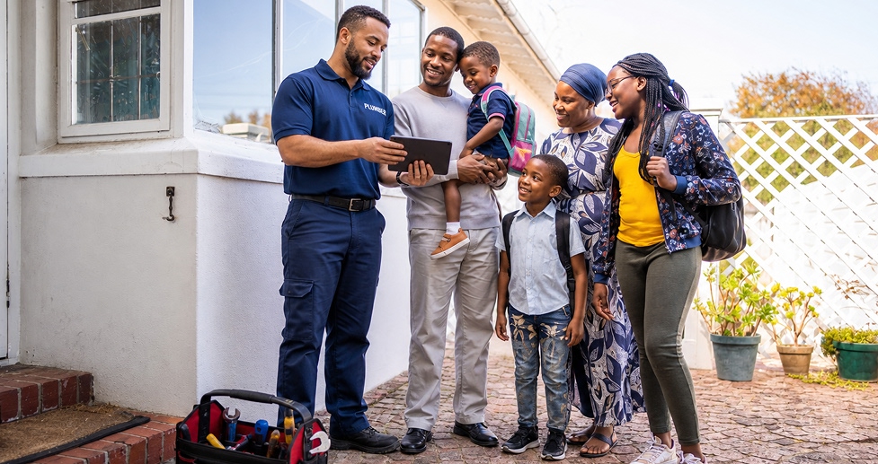 Electrician presenting professional quote to homeowner on tablet device in South Africa